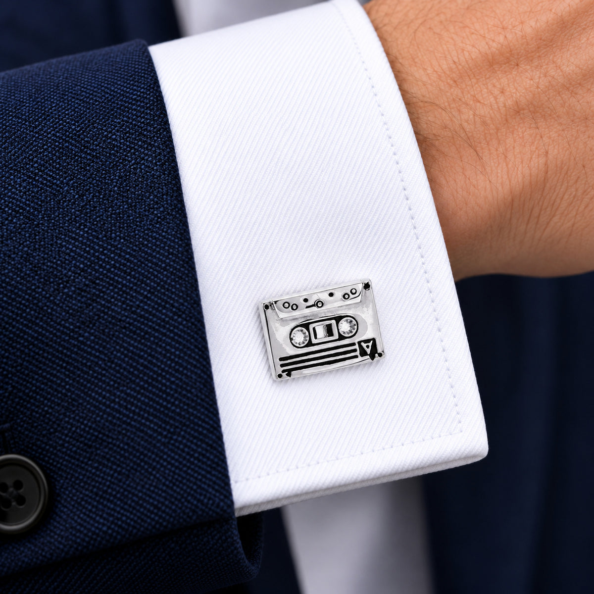 Gemelos Cinta y Radiocassette. Gemelo con forma de cinta de casete en el puño blanco de una camisa.