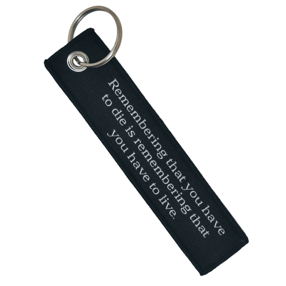 Double-sided embroidered Fabric Keychain with Memento Mori Phrase 13 x 3 cm